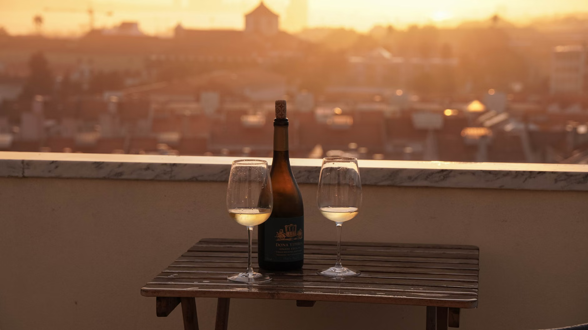 rooftop wine glasses sunset